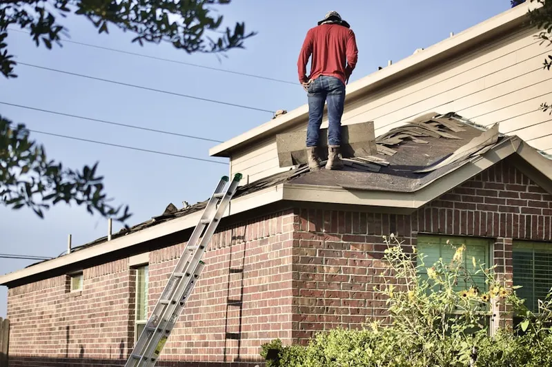 Professional roofer working on a residential roof in Highland Park - Overlee Knolls